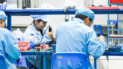 Skilled technicians assembling CRSMT POS hardware